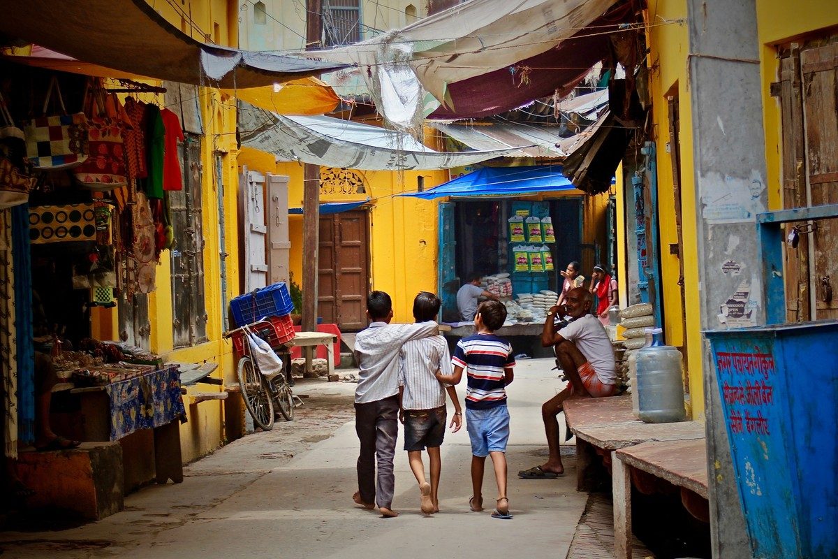Children walking down a street in India